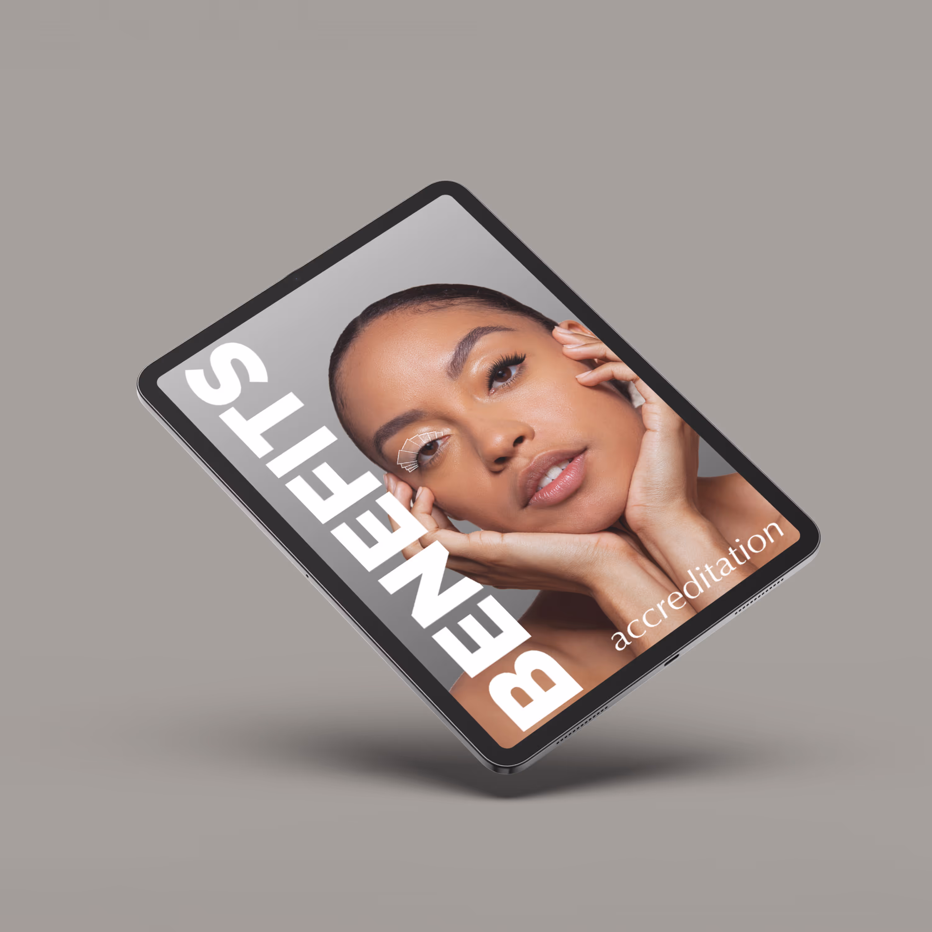 Tablet displaying a close-up of a woman's face with the text 'BENEFITS' and 'accreditation' on a gray background.
